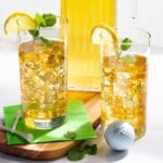arnold palmer tea in a glass with mint and lemon, masters golf ball next to it