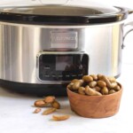 Boiled peanuts crockpot in front of cooker.