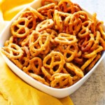 Copycat Gardetto Mustard Pretzels in a white bowl with yellow napkin