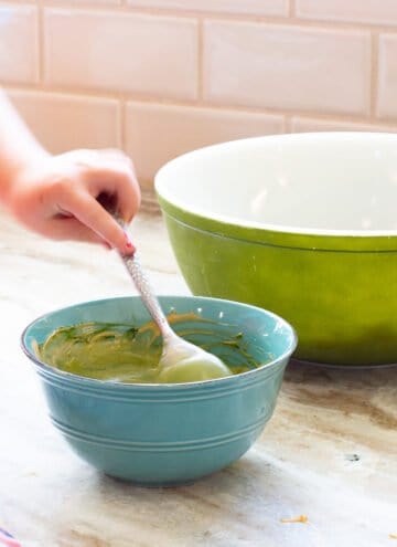 mixing green food coloring into peanut butter and chocolate