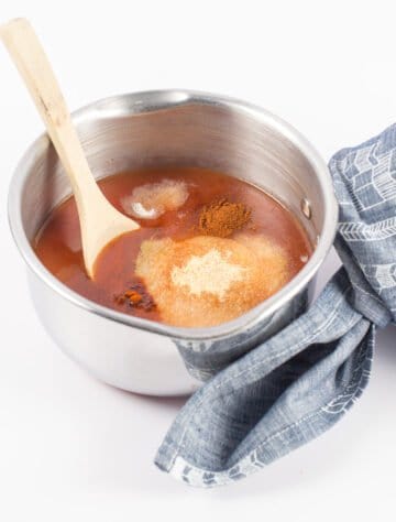 taco bell copycat red sauce in a pan getting ready to simmer