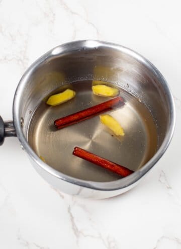 Simple syrup be made for a cocktail in a pan with fresh ginger and cinnamon sticks