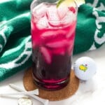 transfusion drink in glas with masters golf ball and towel next to it.