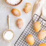 Copycat Starbucks Madeleine on a cooling rack with powdered sugar on them