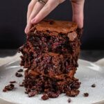 hand grabbing a stack of moist cake brownies