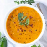 Mexican tomato soup in a bowl with jalapeno and cilantro on top.