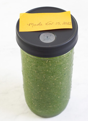 fermented salsa in a ball quart jar with fermenting lid and date written on a paper