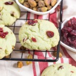 pistachio cookies with cranberry on top with pistachios in a bowl