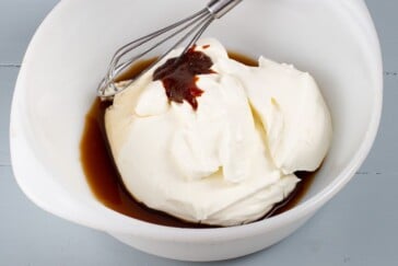 Sour cream soy sauce and bouillon in a bowl being ready to whisk