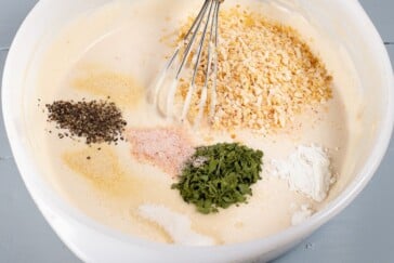 Seasonings to make french onion dip recipe sprinkled on top of sour cream mixture