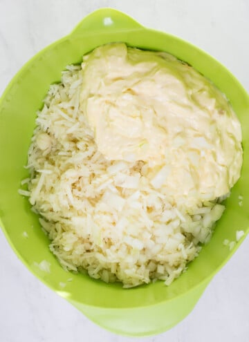 bowl with shredded frozen potatoes and cream cheese mixture