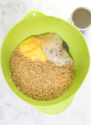 bowl with rice, 2 cans cream soups, pepper and a can of water near it