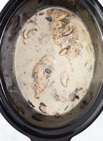 cooked chicken with mushroom cream sauce in a crock pot