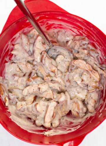 bowl with cream sauce stirred into mushrooms