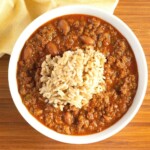 zippy's chili in a bowl with a scoop of rice on top