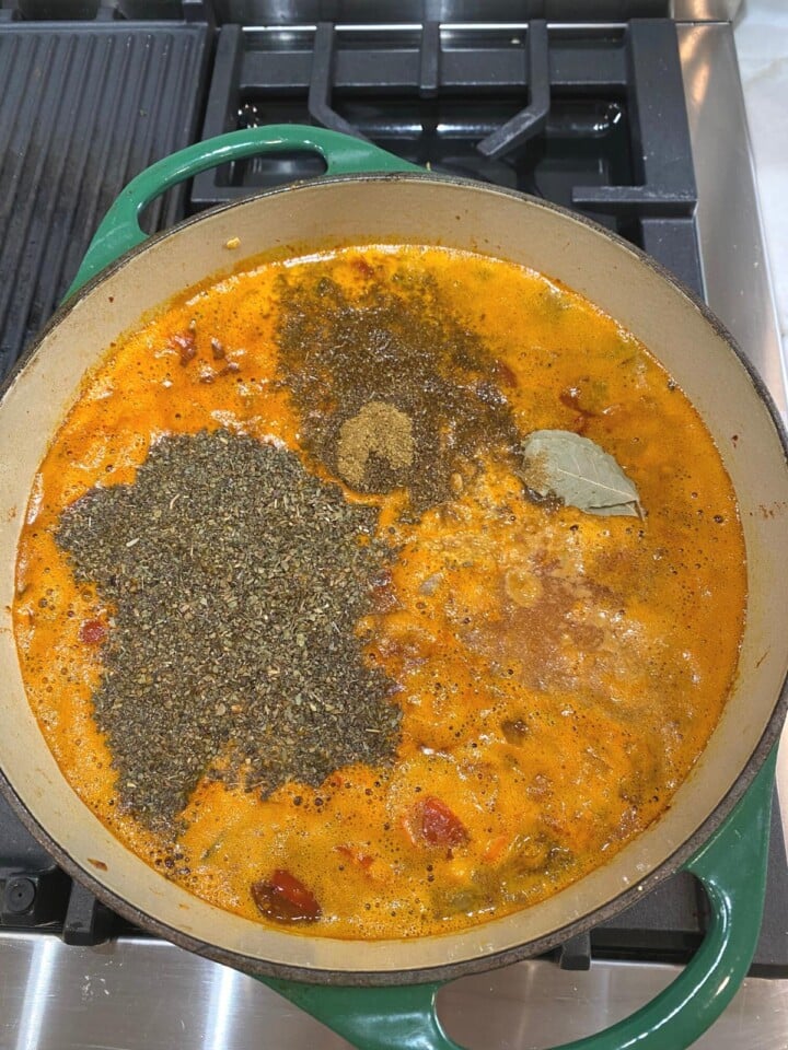 seasonings and bay added to soup