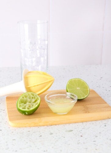 lime cut in half with one side being juiced and other cut for garnish