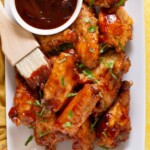 Close up of bbq wings from a slow cooker using 3 ingredients covered in sauce.