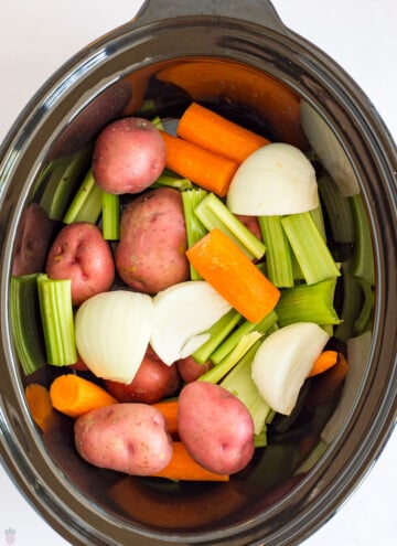 Pot Roast carrots, onions, potatoes, celery in bottom of crockpot
