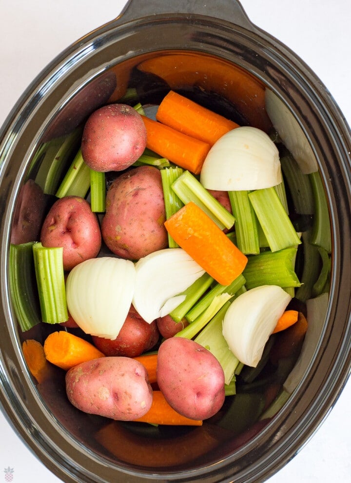 Pot Roast carrots, onions, potatoes, celery in bottom of crockpot