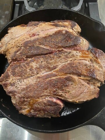 seared chuck roast in cast iron skillet