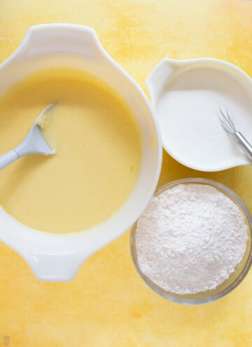 creamed butter, sugar and eggs in a bowl, sour cream and flour in other bowls