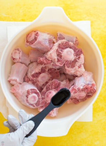 oxtail in a bowl with vinegar going in