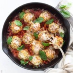 Cheesy Baked Chicken Parmesan Meatballs in a cast iron skillet