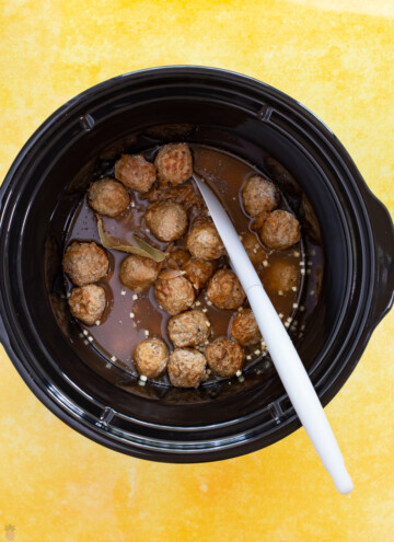 meatballs in gravy in a crock pot before cooking