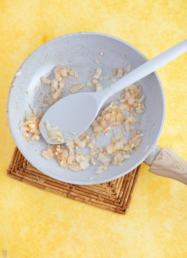 cooking onions for chicken mexican soup in a pan