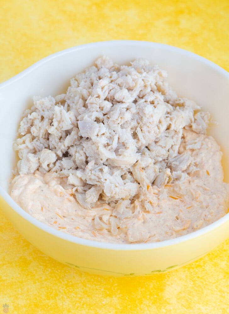 crab dip mixture with lump crab meat on top in a mixing bowl