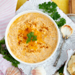 Creamy Maryland Crab Dip with melted cheese and old bay sprinkled on top.