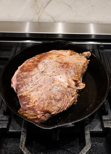 seared sirloin tip roast on stove in black skillet