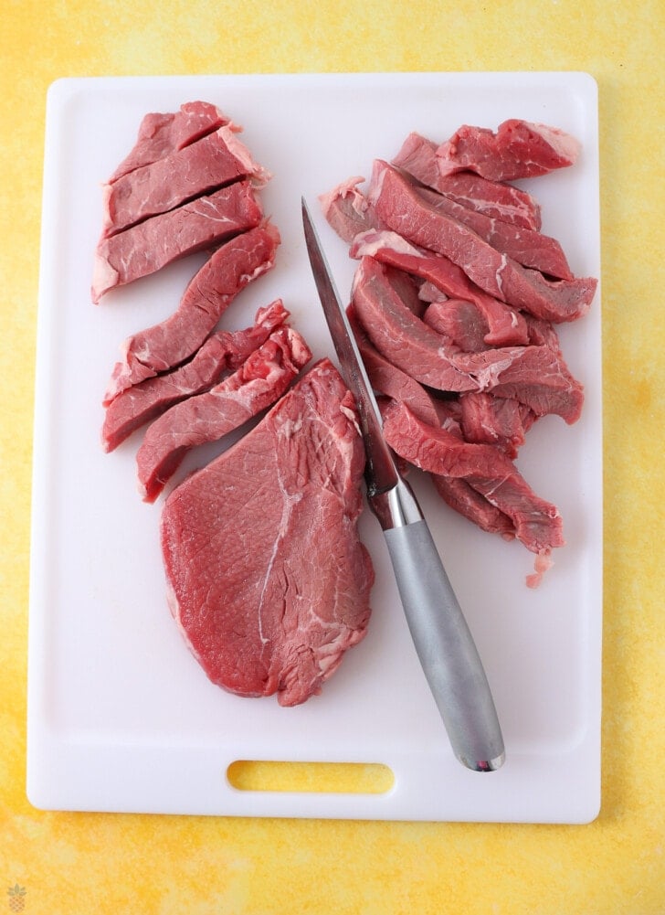steak being cut into strips
