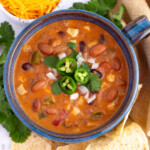 taco soup recipe with ranch dressing and velveeta cheese in a bowl topped with cilantro