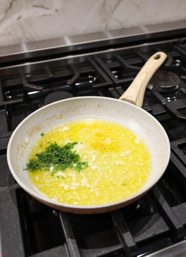 Lemon garlic butter being simmered and then the parsley is added