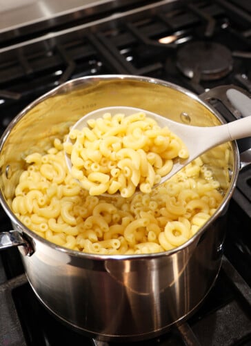 cooked macaroni noodles in a pan on the stove.