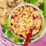 spicy pimento cheese in a bowl with cracker and celery stickls