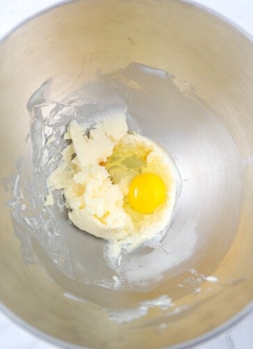 Butter that has been whipped in a bowl and then an egg and vanilla added