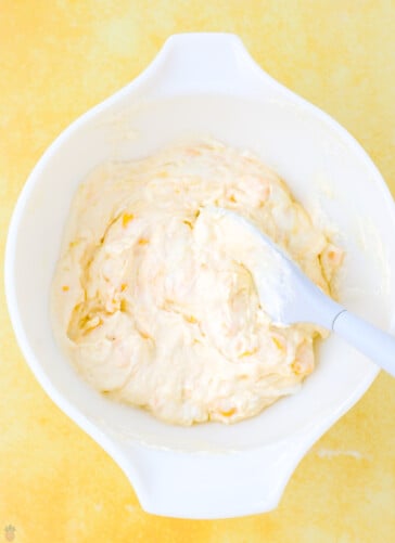 The combination of cheeses Blended together in a bowl for crockpot taco dip