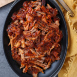 Pulled pork that has had extra sauce added after it was shredded