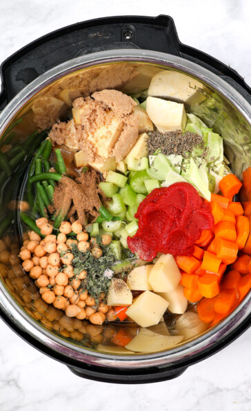Seasonings on top of vegetables for instant pot veggie stew brown sugar time tomato paste oregano salt and pepper Worcestershire cumin