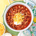 Bobby Jones Calamity Jane beer chili in a bowl with black eyed peas white corn pinto beans hamburger topped with shredded cheese