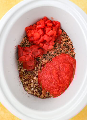 Hamburger for Beer chili in a crock pot with diced tomatoes crushed tomatoes and tomato paste