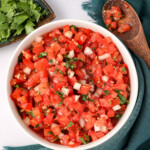 Homemade Salsa Fresca in a bowl with cilantro and onions and tomatoes in it