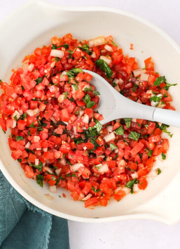 Fresh homemadeSalsa Fresca with chopped tomatoes onions garlic cilantro and Seasonings in a bowl