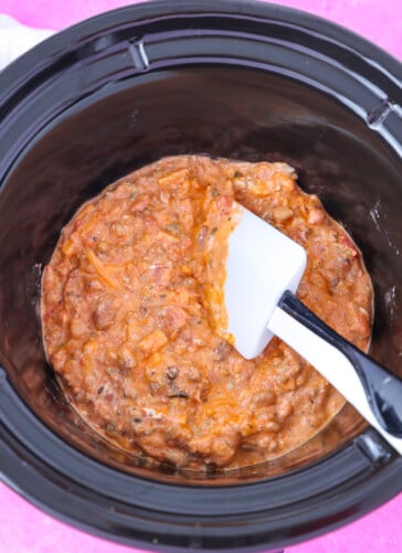 chili cheese dip mixed in a crock pot ready to cook