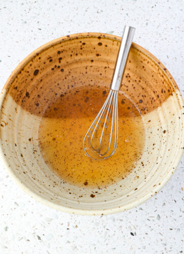 Dressing mix for cucumber salad in a bowl being whisked