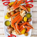 Lowcountry boil made in an instant pot on a large tray with butter melted in bowls and crab crackers