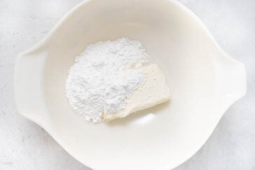 cream cheese and powdered sugar in bowl